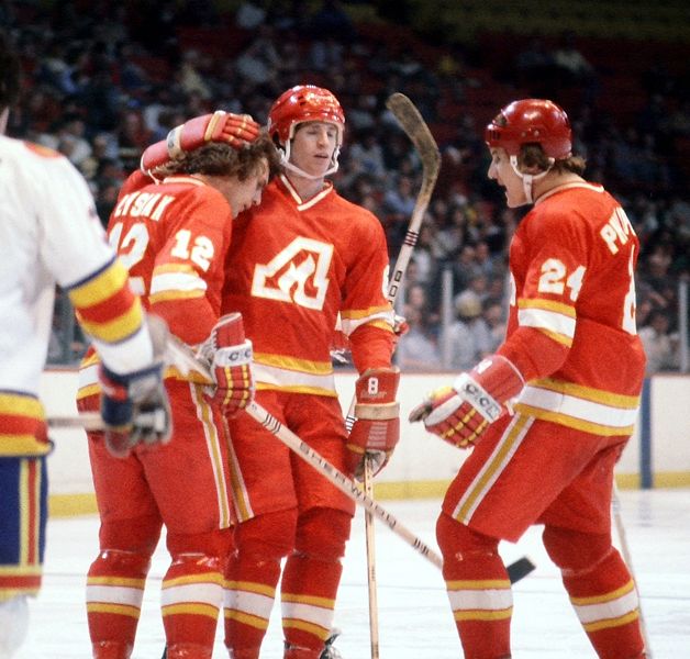 Tom Lysiak (left) celebrates a goal with Atlanta Flames teammates in a game with the Colorado Rockies in 1978.