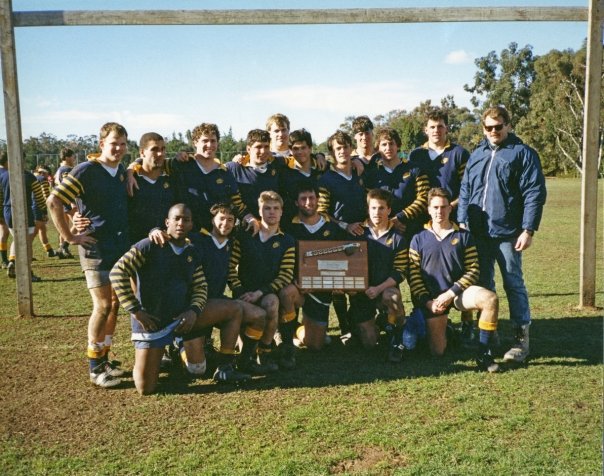 English:   The University of California Rugby team in possession of the scrum axe.