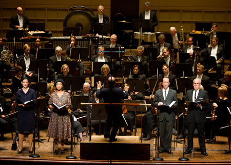 The w:Dallas Symphony Orchestra, under the direction of w:Jaap van Zweden, presents the premiere of w:Steven Stucky's oratorio w:August 4, 1964, with soloists, from left, mezzo-soprano w:Kelley O'Connor, soprano w:Laquita Mitchell, tenor w:Vale Rideout, and baritone w:Robert Orth.